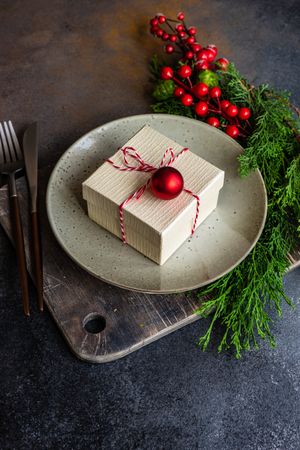 Christmas holiday concept with gift on grey plate