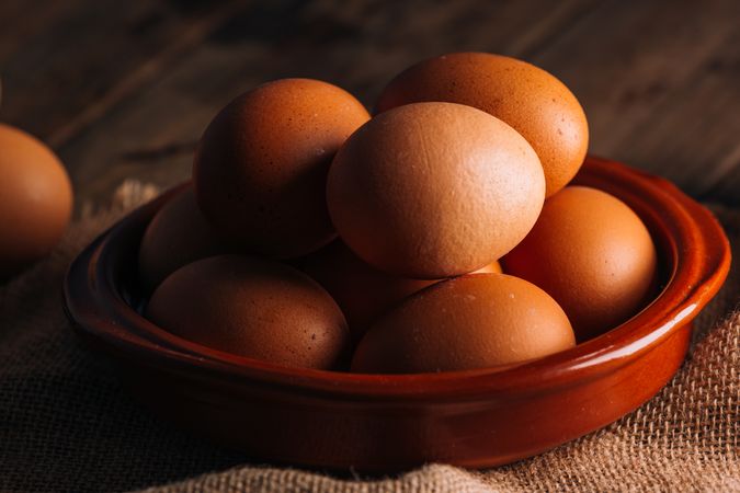 Chicken eggs on napkin on wooden table
