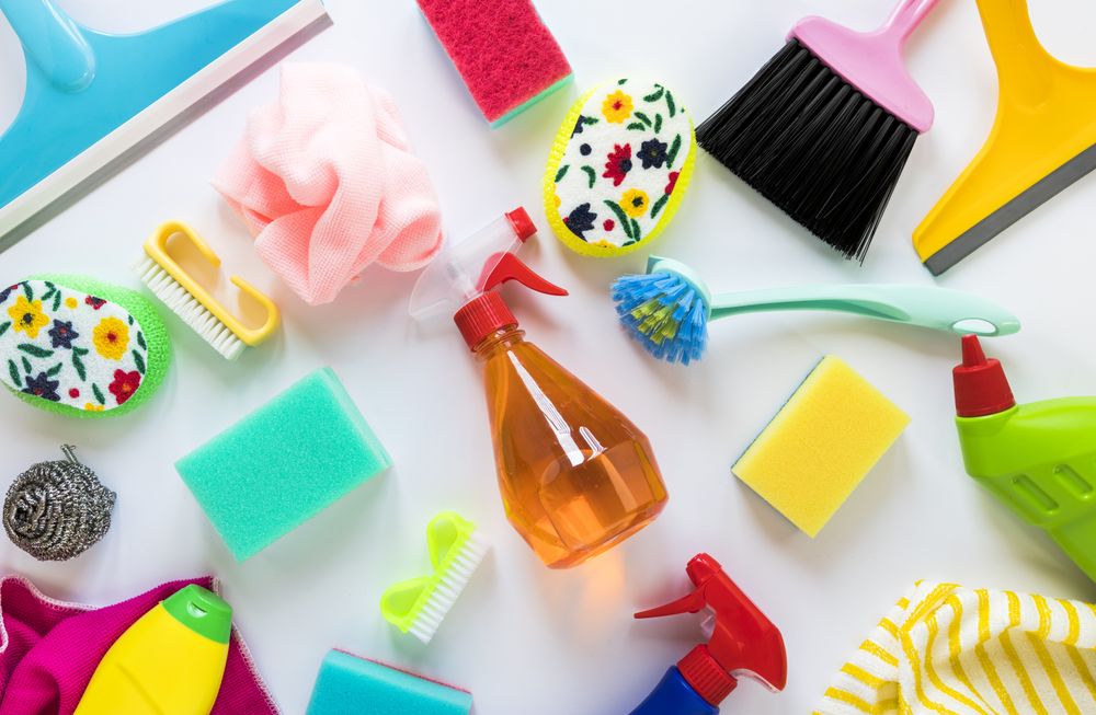 Above view of arrangement with cleaning solutions and cloths