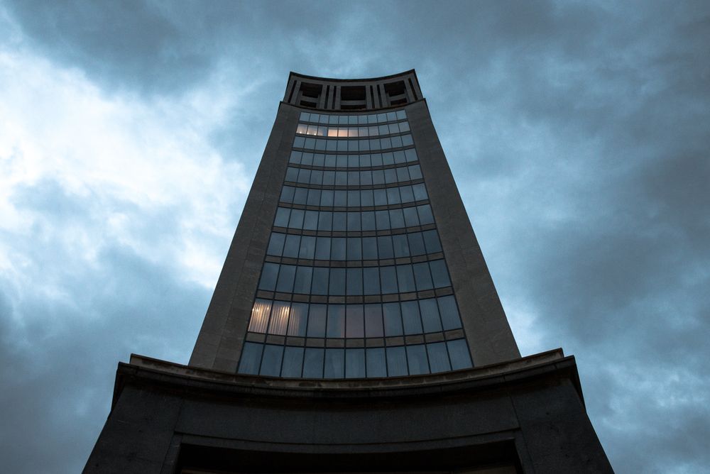 Contemporary highrise building under cloudy sky
