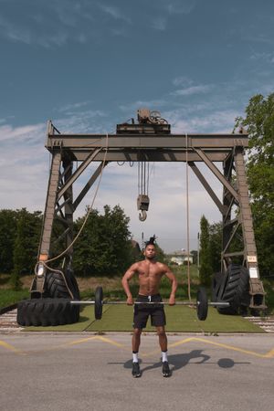 Black guy with barbell in outdoor gym