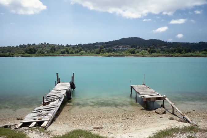 Wooden broken old pier in calm water
