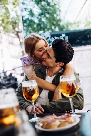 Happy young couple drinking beverages outdoors