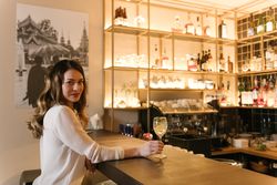 Young woman enjoying cocktail in bar