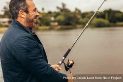 Mature man fishing on overcast day bGxeB0