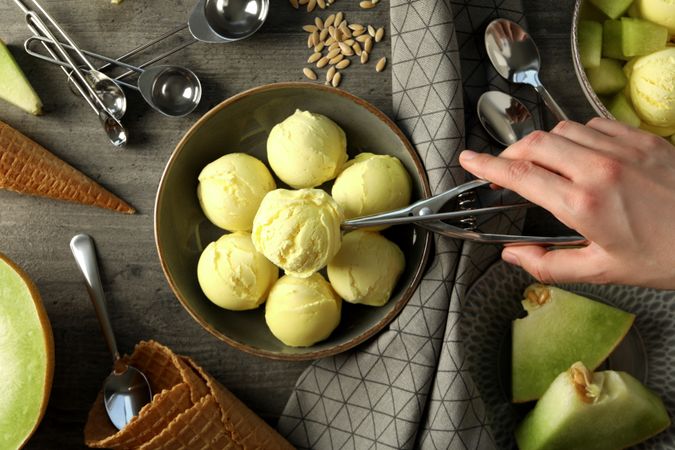 Melon ice cream scoops on a dark background