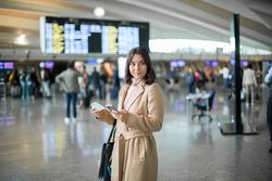 Woman using smartphone at airport