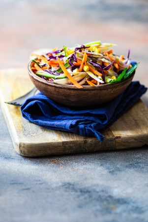 Fresh salad with finely chopped vegetables in bowl with copy space