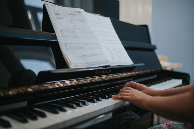 Student learning new music on the piano