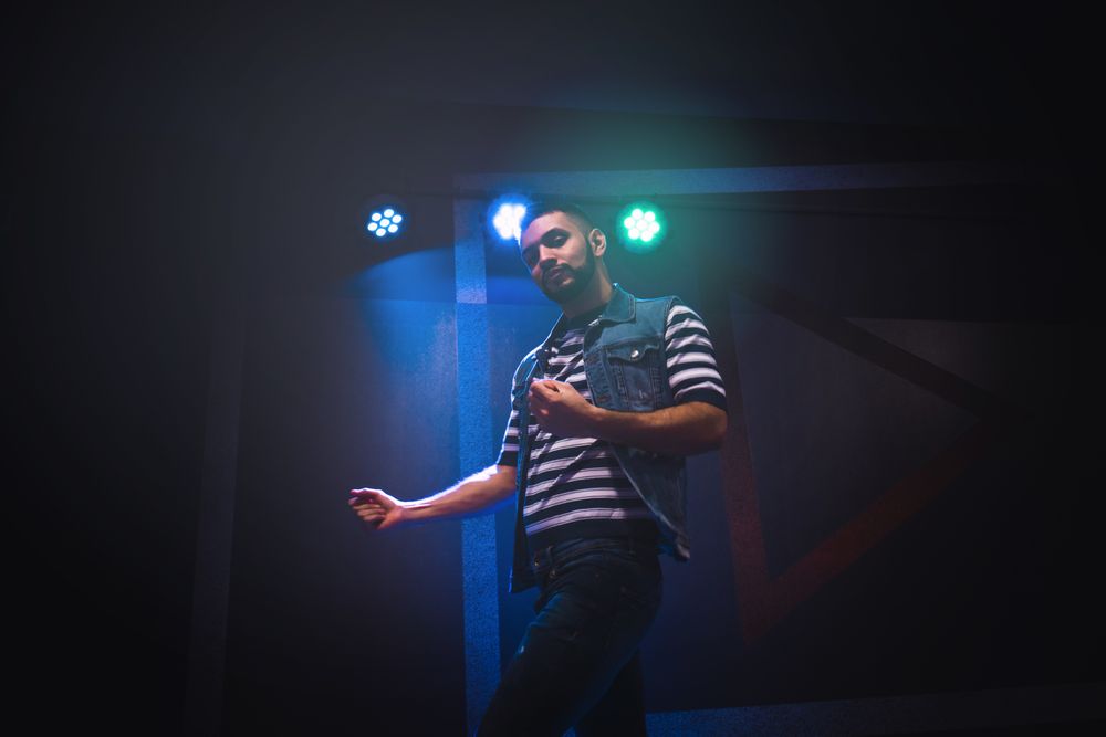 bearded man dancing in spotlight
