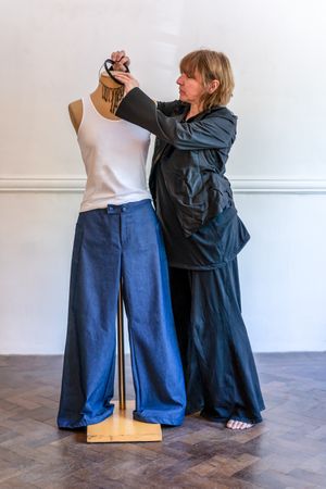 Fashion designer dressing a mannequin