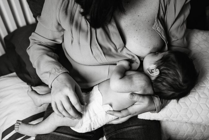 Mom breastfeeding at home