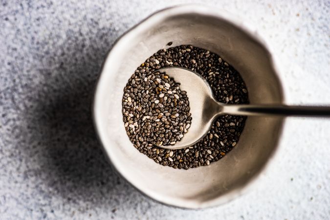 Organic chia seeds in ceramic bowl