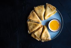 Top view of plate of pancakes with honey