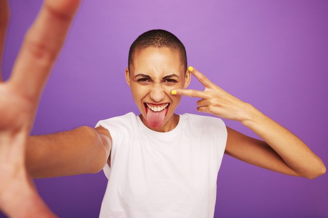 Portrait of expressive woman posing on purple background