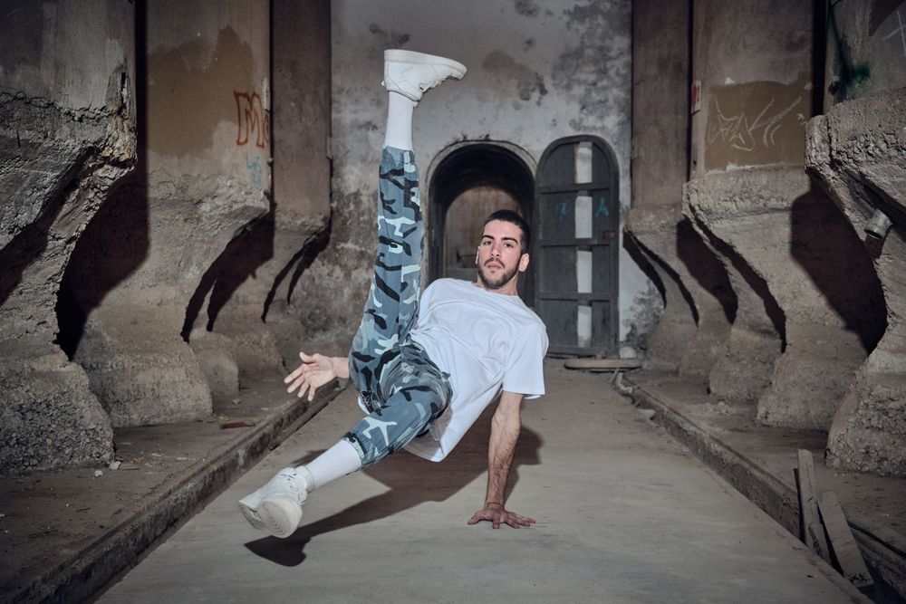 Active man break dancing in abandoned building