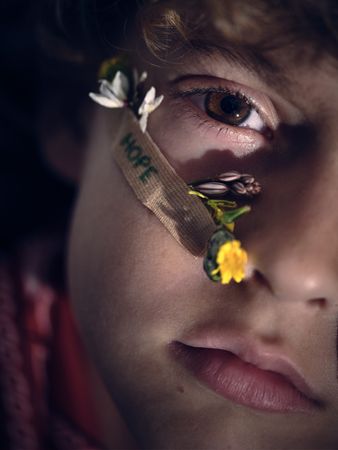 Face of child with flowers under eyes