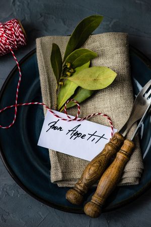Bon appetit note on napkin with bay leaf with string