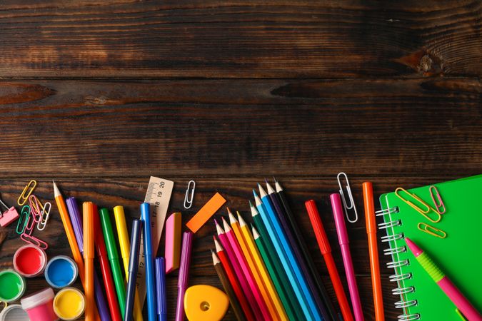 Flat lay composition with school supplies on wooden background, space for text
