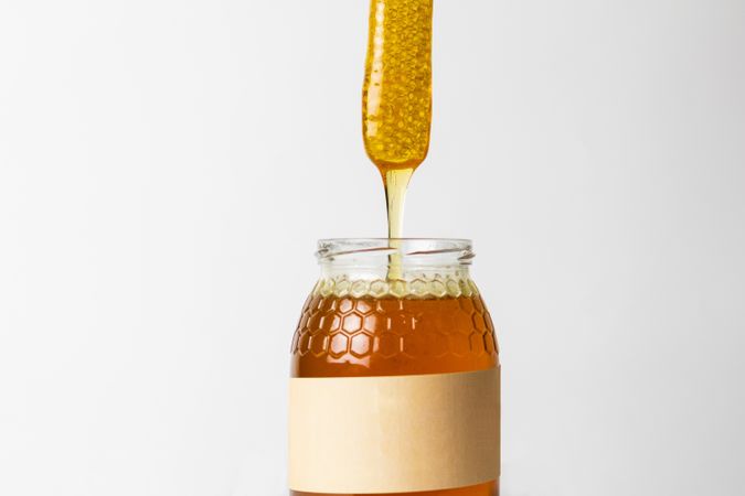 Honey with honeycomb in glass jar