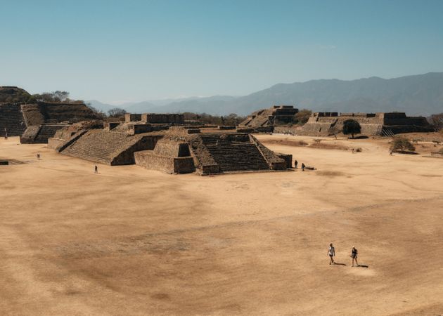 Looking down over pyramids outside of Oaxaca with people walking
