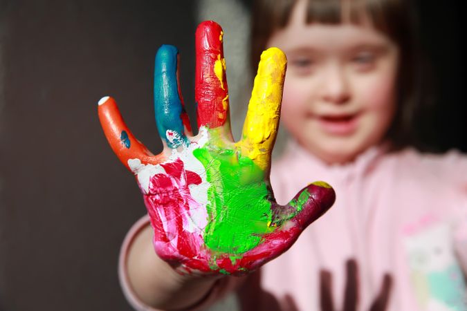 Close up of childs painted hand in focus