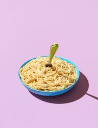 Cheese spaghetti bowl isolated on a purple background