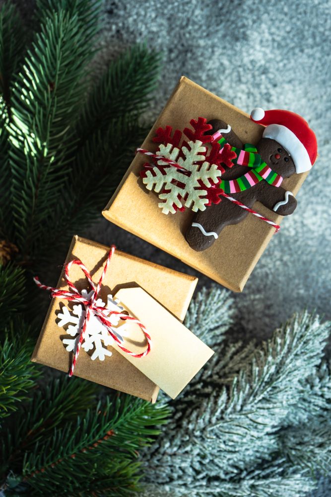 Christmas gifts with pine and gingerbread ornament