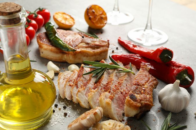 Composition with fried steaks and spices. Grilled food
