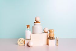 Natural self care products stacked up with blue backdrop