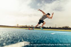 Side View Of Sprinter Taking Off From Starting Block On Running Track ...