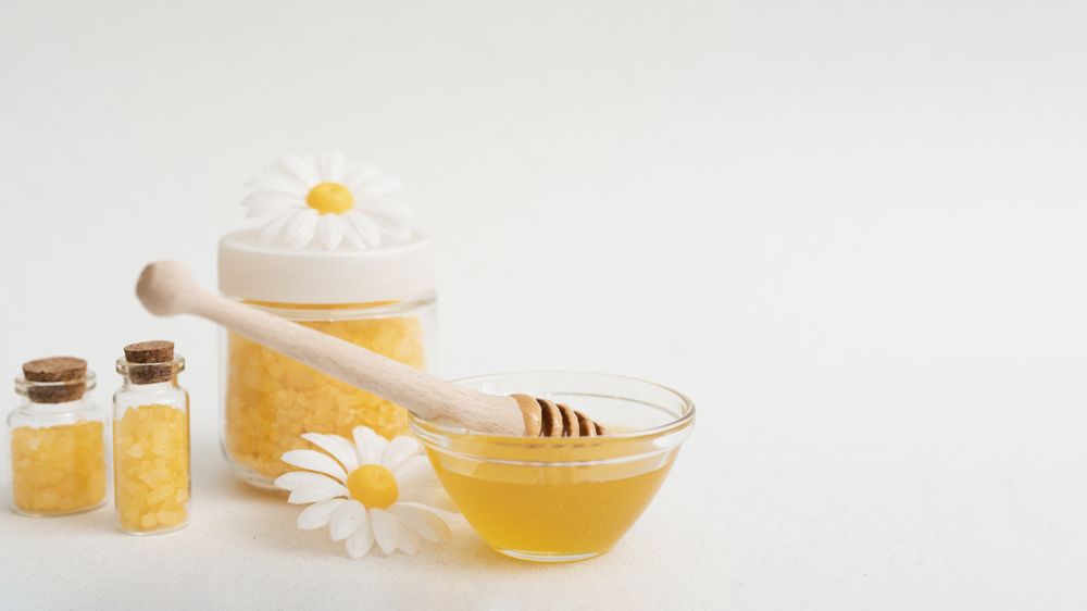 Arrangement with honey and bath salts with copy space