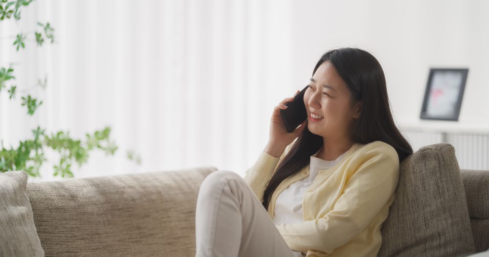 Portrait of an Engaged Young South Korean Female Having an Inspiring Phone Call