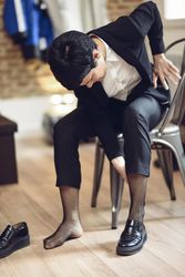 Woman with short hair putting on her loafers