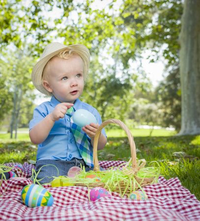 Cute Little Boy Enjoying His Easter Eggs Outside in Park