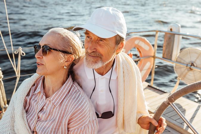 Calm older couple relaxing on boat