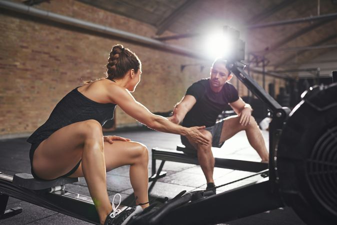 Fit young couple giving high five before starting intense workout