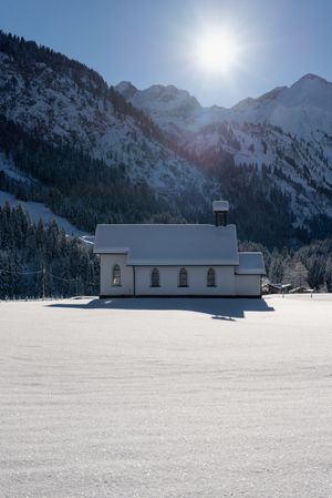 Sunny winter scenery with deep snow nature and bright sun in the sky