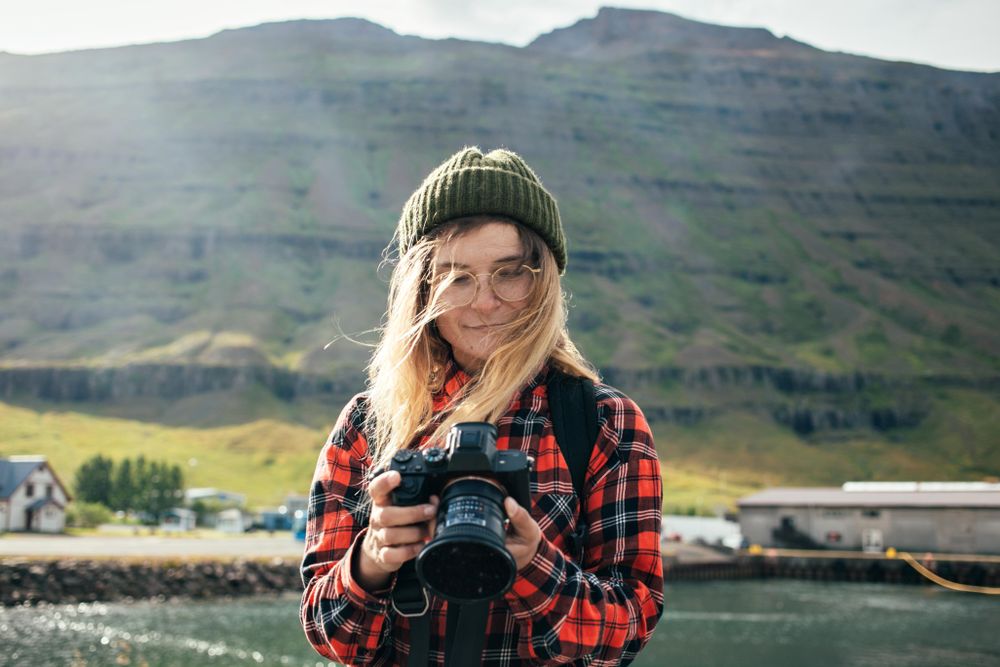 Woman checking photos she took on camera