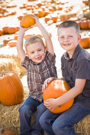 Two Boys at the Pumpkin Patch Talking and Having Fun.