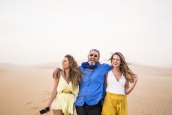 Happy friends walking in desert