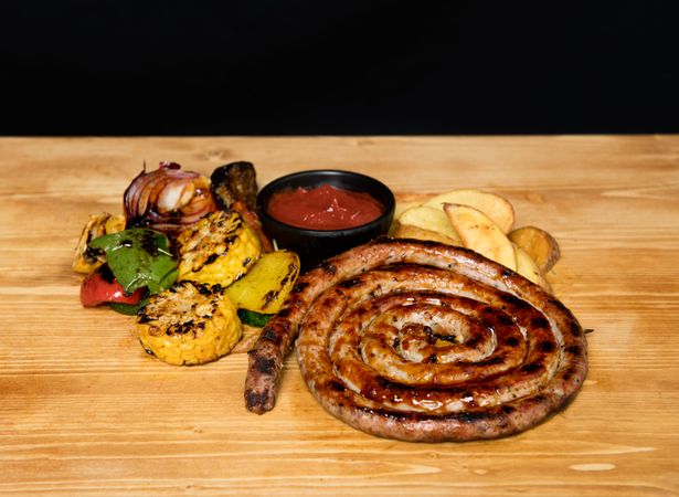 Fried meat and vegetables near ketchup