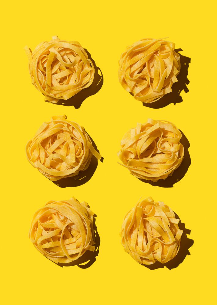 Bird's nest pasta organized over yellow background