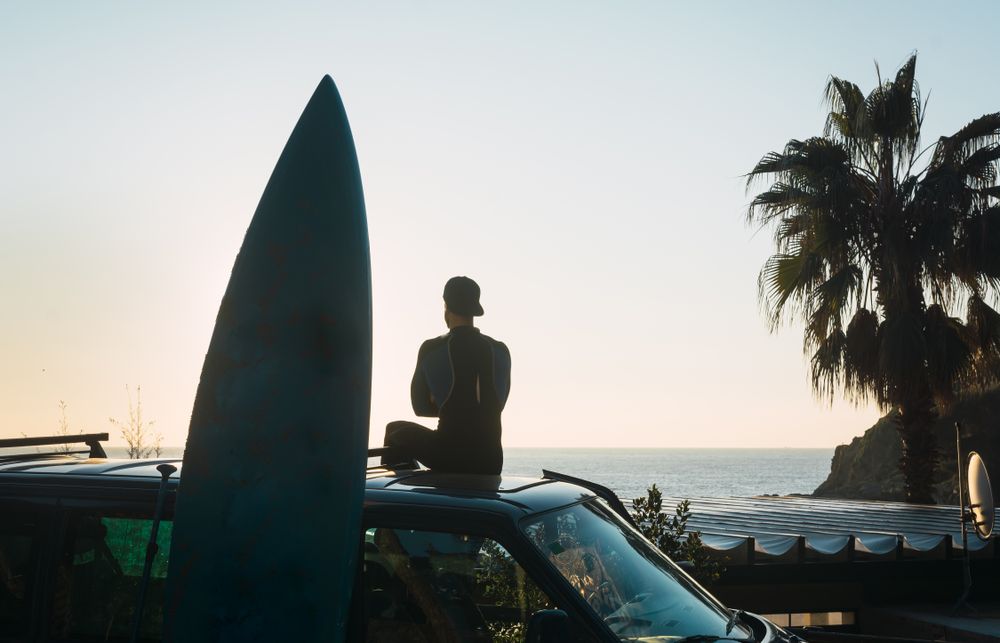 Man enjoying the sunrise in his camped van