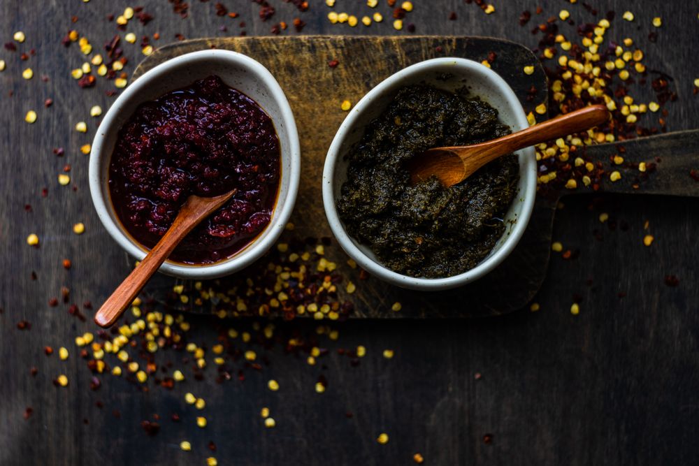 Two rustic pots of traditional Georgian sauce Adjika