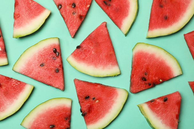 Composition with fresh watermelon slices on mint background, top view