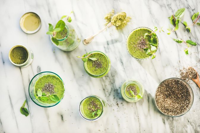 Top view of green healthy juices topped with chia seeds