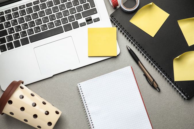 Laptop, Notebook and Plastic Coffee Cup on Table, Top View