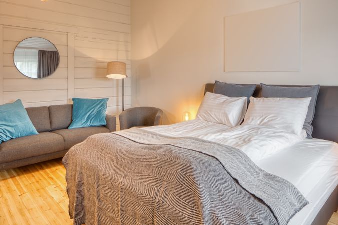 Cozy interior of bedroom with sofa