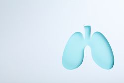 Blue lungs centered on light paper with copy space